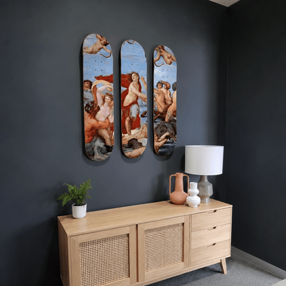 A light wood sideboard cabinet with woven cane panels, styled in a modern room against a dark gray wall with three vertical art prints above it.